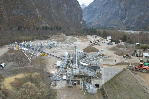 Vue aérienne de la carrière d’Auris et de ses installations de production de granulats, au cœur du massif montagneux.