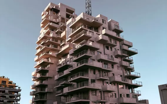 Immeuble résidentiel en construction avec structure béton apparente, illustrant un projet d’aménagement urbain en phase de gros œuvre.