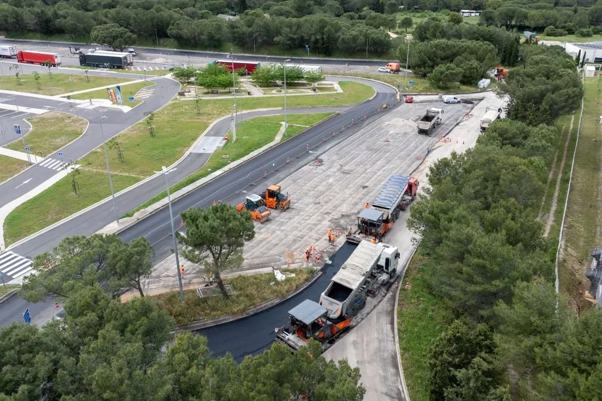 Travaux routiers à Ambrussum avec mise en œuvre d’enrobé et engins de chantier pour aménagement de voirie.